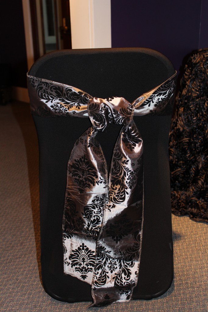 Back view of folding chair cover and grey flocked sash